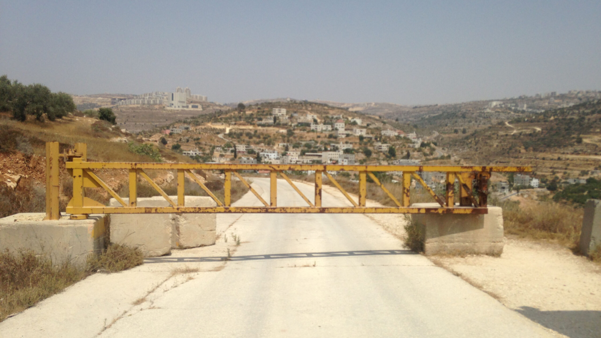 A road near the Israeli settlement of Dolev, where a gate blocks Palestinians from the nearby village of Ein Qinya from driving to the main road.